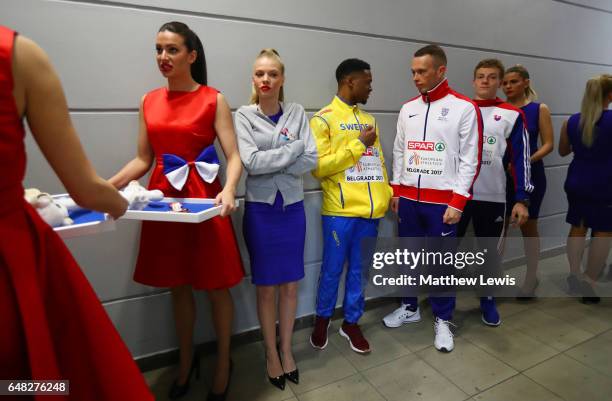 Richard Kilty of Great Britain talks to Austin Hamilton of Sweden, as they wait for the medal ceremony for the Mens 60m Final on day three of the...