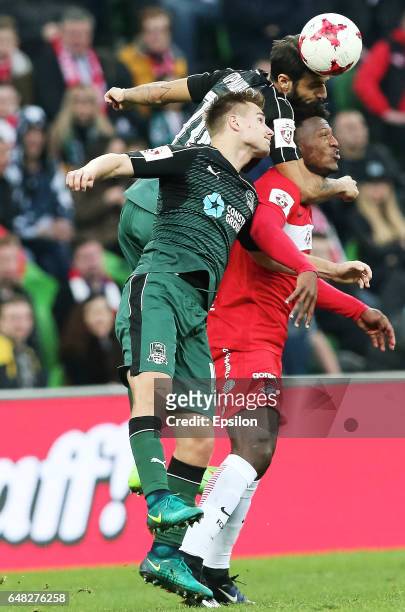 Ilya Zhigulyov and Tornike Okriashvili of FC Krasnodar is challenged by Ze Luis of FC Spartak Moscow during the Russian Premier League match between...