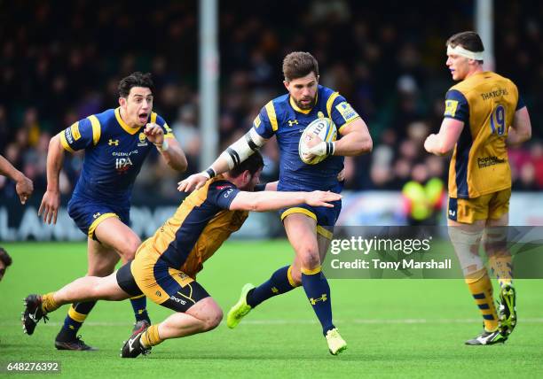 Wynand Olivier of Worcester Warriors is tackled by Marc Jones of Bristol Rugby during the Aviva Premiership match between Worcester Warriors and...