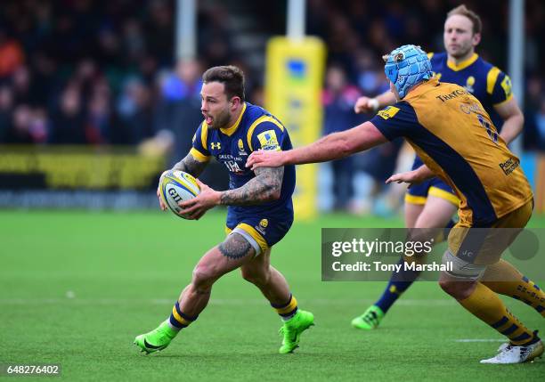 Francois Hougaard of Worcester Warriors is tackled by Jordan Crane of Bristol Rugby during the Aviva Premiership match between Worcester Warriors and...