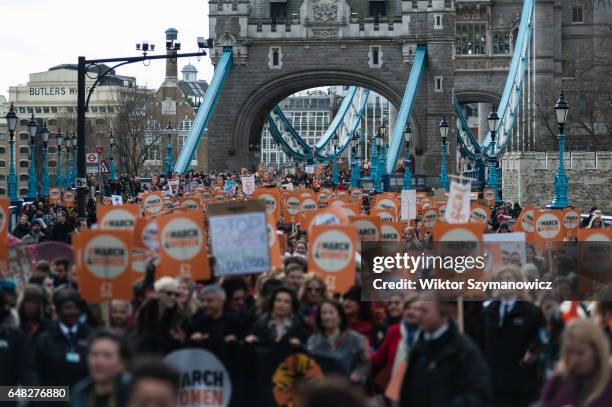 Hundreds of people march across Tower Bridge led by Annie Lennox, the Mayor of London Sadiq Khan, Bianca Jagger, Helen Pankhurst during March4Women...