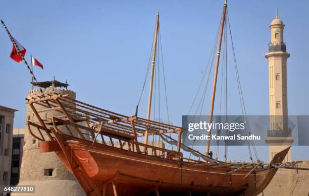 a traditional boat moored outside of al fahidi fort or dubai museum - al fahidi fort stock-fotos und bilder