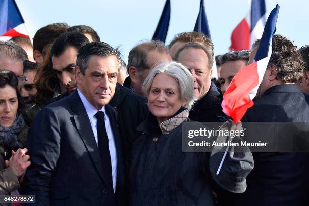 Former Prime Minister and Presidential Candidate Francois Fillon and his wife Penelope Fillon salute voters after a political meeting at Trocadero on...