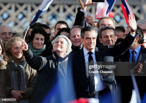 French presidential election candidate for the right-wing "Les Republicains" party Francois Fillon, flanked by his wife Penelope Fillon acknowledges...