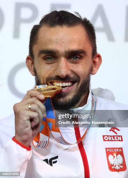 Gold medalist Adam Kszczot of Poland poses during the medal ceremony for the Men's 800 metres on day three of the 2017 European Athletics Indoor...