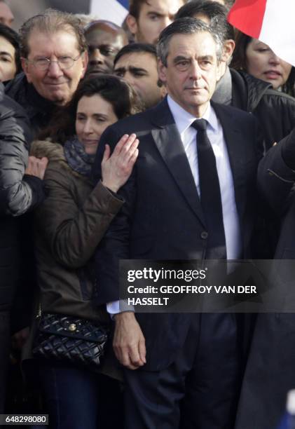 French presidential election candidate for the right-wing Les Republicains party Francois Fillon , stands on stage next to his daughter Marie Fillon...