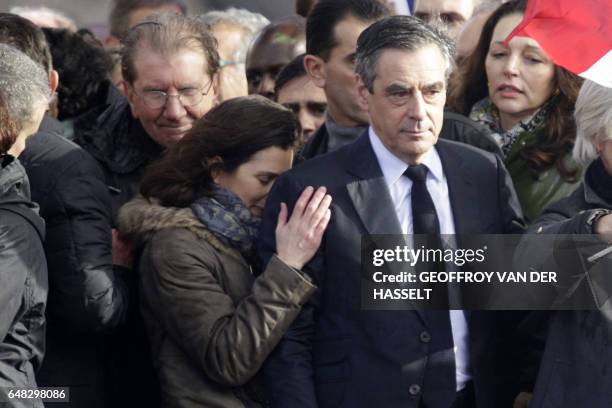 French presidential election candidate for the right-wing Les Republicains party Francois Fillon , stands on stage next to his daughter Marie Fillon...
