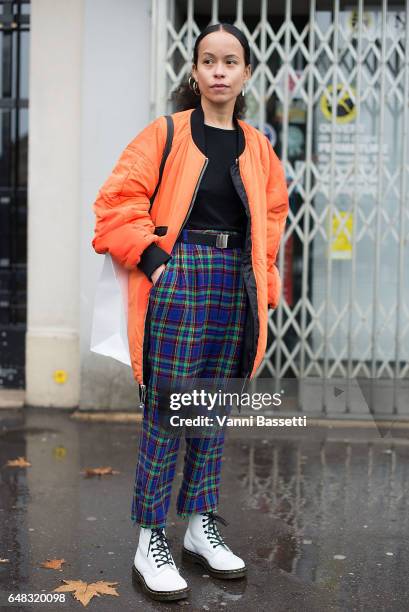 Guest poses wearing Dr. Martens boots after the Celine show at the tennis Club de Paris during Paris Fashion Week Womenswear FW 17/18 on March 5,...