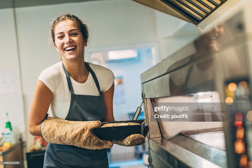 Beautiful baker holding hot bread