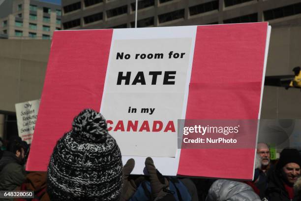 Pro-Muslim protestor carrying a sign saying 'No Room for Hate in My Canada' as opposing groups of protesters clashed over the M-103 motion to fight...