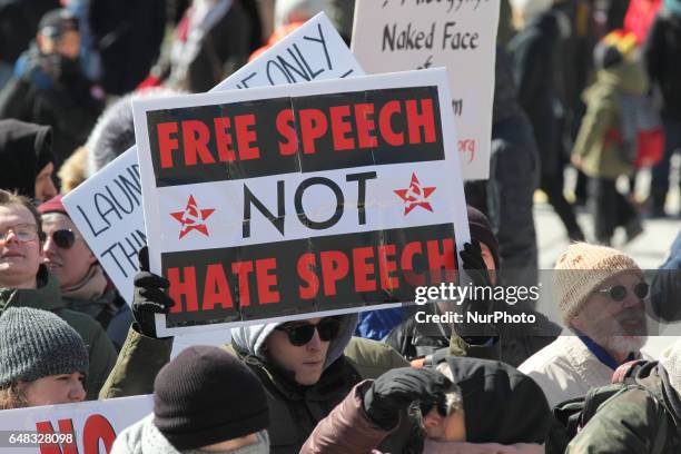 Pro-Muslim protestor carrying a sign saying 'Free Speech NOT Hate Speech' as opposing groups of protesters clashed over the M-103 motion to fight...