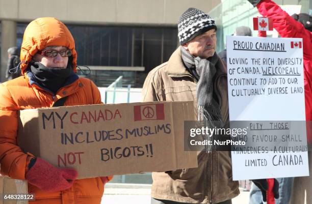 Pro-Muslim demonstrators hold a counter-protest against anti-Muslim groups over the M-103 motion to fight Islamophobia in downtown Toronto, Ontario,...