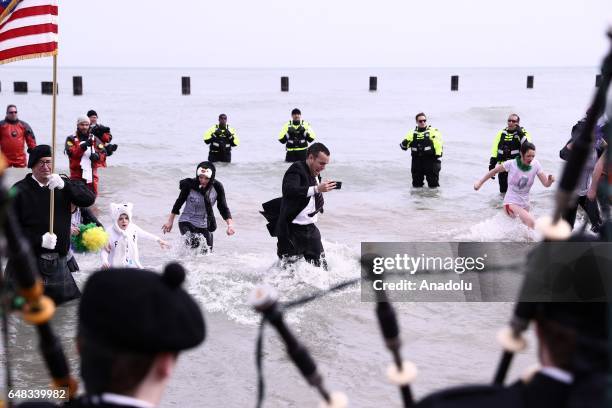 People take part in the 17th Annual Chicago Polar Plunge organized to support the athletes of Special Olympics at North Ave Beach of Michigan Lake in...