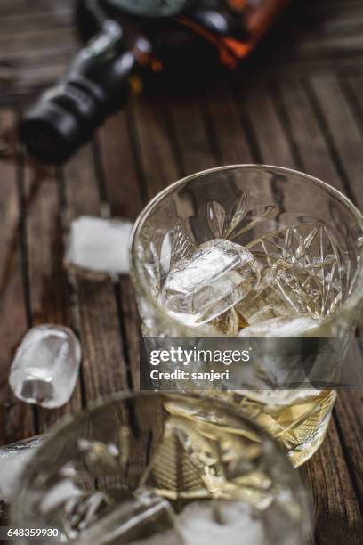 whiskey in a glass with ice cubes - scotch whisky stock pictures, royalty-free photos & images