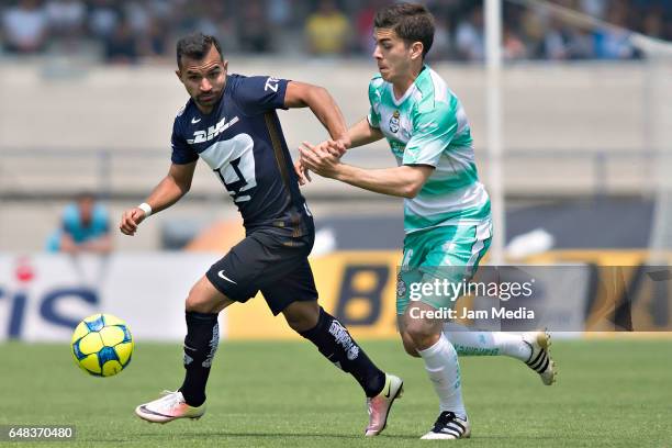 Bryan Rabello of Pumas fights for the ball with Diego De Buen of Santos during a match between Pumas UNAM and Santos Laguna as part of the Torneo...