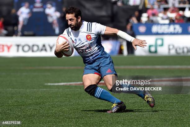 Julien Candelon of France carries the ball against Kenya on day three of the USA Sevens Rugby tournament, part of the World Rugby Sevens Series,...