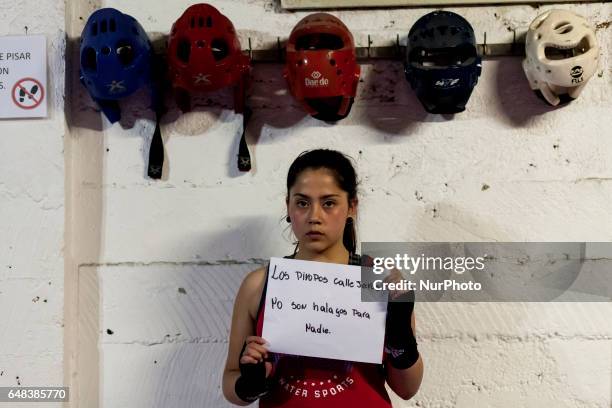 Osorno, Chile. 24 January 2017. The amateur boxer Macarena Vásquez, 14 years old and belonging to the Boxing School Ta Mi Chau poses with a sign that...