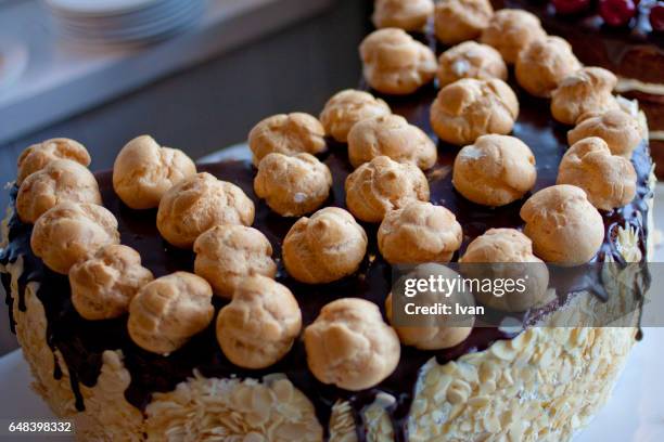 chocolate and cream cake decelerated with flaked almond and puffs - sugared almond stock pictures, royalty-free photos & images