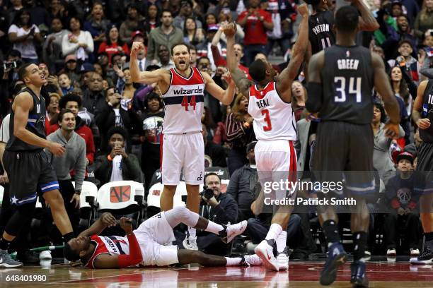 Bojan Bogdanovic, Bradley Beal and John Wall of the Washington Wizards celebrate after defeating Aaron Gordon and the Orlando Magic at Verizon Center...