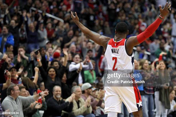 John Wall of the Washington Wizards reacts after teammate Bojan Bogdanovic , scored the game-winning basket against the Orlando Magic during the...