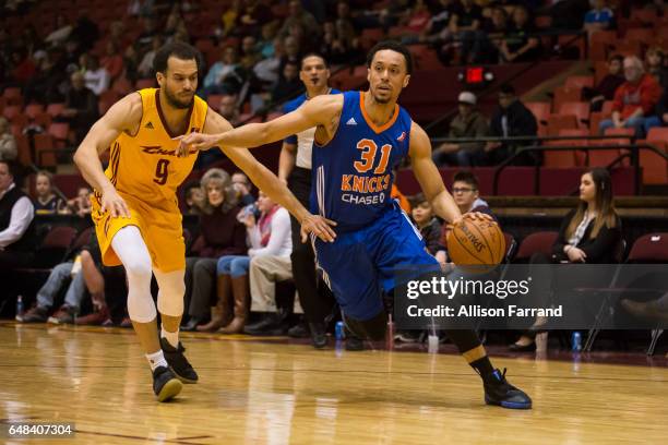 John Jenkins of the Westchester Knicks drives against Cameron Jones of the Canton Charge at the Canton Memorial Civic Center on March 5, 2017 in...