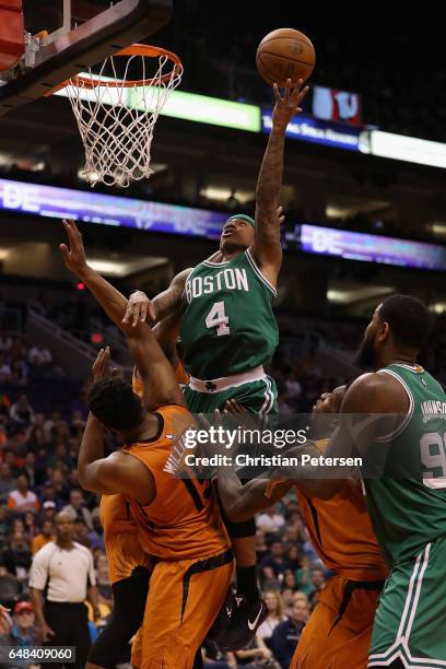 Isaiah Thomas of the Boston Celtics attempts a lay up over Alan Williams of the Phoenix Suns during the second half of the NBA game at Talking Stick...