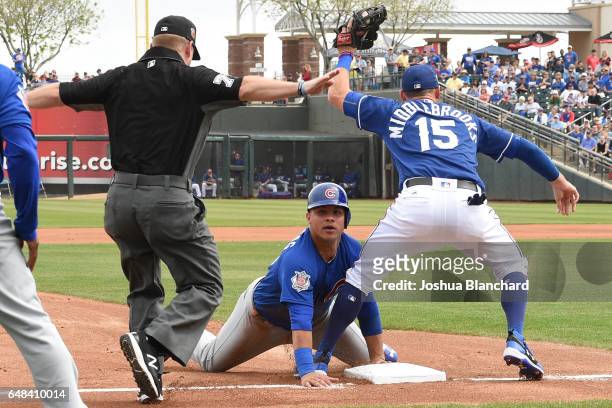 Wilson Contreras of the Chicago Cubs slides safely into third base as Will Middlebrooks of the Texas Rangers is late with the tag at Surprise Stadium...