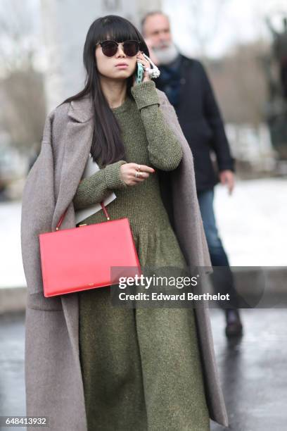 Leaf Greener wears a red bag, and a green dress, outside the Mashama show, during Paris Fashion Week Womenswear Fall/Winter 2017/2018, on March 5,...