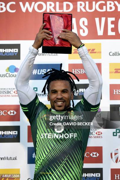 Rosko Specman of South Africa raises his most valuable player trophy after South Africa defeated Fiji, 19-12, in the Cup Final match during the USA...