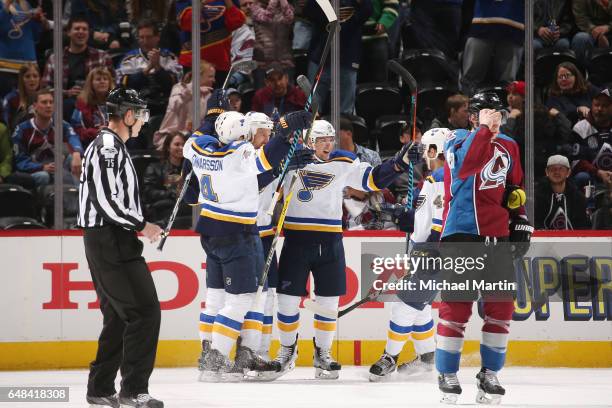 Kyle Brodziak of the St. Louis Blues celebrates with teammates: Scottie Upshall, Jordan Schmaltz and Carl Gunnarsson after scoring a goal against the...