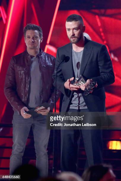 Actor Jeremy Renner listens as musician Justin Timberlake accepts the Song of the Year award for 'Can't Stop the Feeling!' onstage at the 2017...