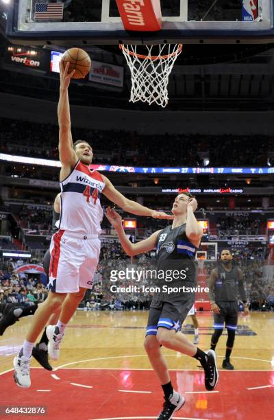 Washington Wizards guard Bojan Bogdanovic scores in the first half against Orlando Magic center Stephen Zimmerman on March 5 at the Verizon Center in...