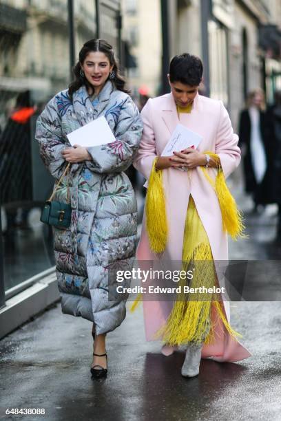 Deena Aljuhani Abdulaziz wears a pink coat, and a yellow fringed dress, outside the Valentino show, during Paris Fashion Week Womenswear Fall/Winter...