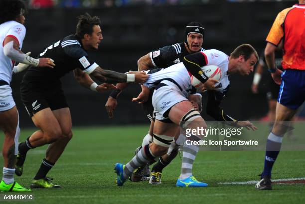 New Zealand player Ambrose Curtis, left, tackles United States player Ben Pinkelman during their sevens rugby match at the HSBC USA Sevens rugby...