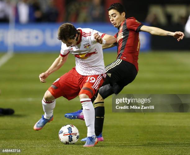 Midfielder Alex Muyl of the New York Red Bulls battles for the ball with midfielder Miguel Almiron of Atlanta United during the game at Bobby Dodd...