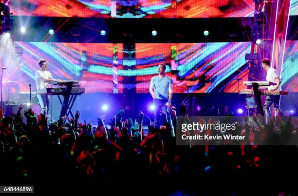 Singer Chris Martin performs with DJs Drew Taggart and Alex Pall of The Chainsmokers onstage at the 2017 iHeartRadio Music Awards which broadcast...