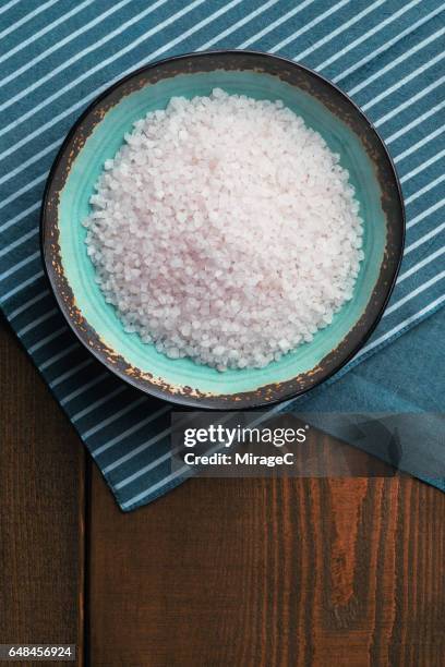 bowl filled with mineral salt on wooden surface - sea salt stock pictures, royalty-free photos & images