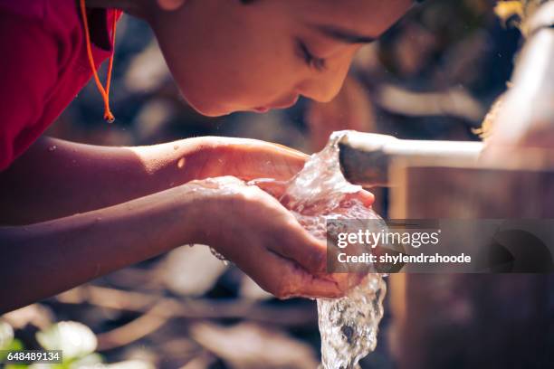 drinking water - boy drinking water stock pictures, royalty-free photos & images