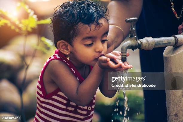 drinking water - india poverty stock pictures, royalty-free photos & images