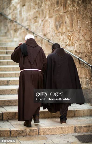 Jerusalem, Israel Two monks in cowls go upstairs in front of the Church of the Holy Sepulchre, historic city center of Jerusalem on February 08, 2017...