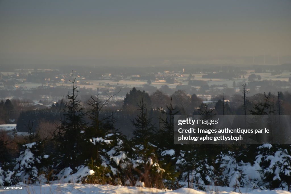 The villages in winter under evening light with haze