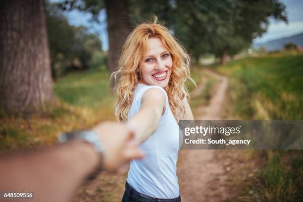 woman holding her man's hand - man holding hand leading stock pictures, royalty-free photos & images