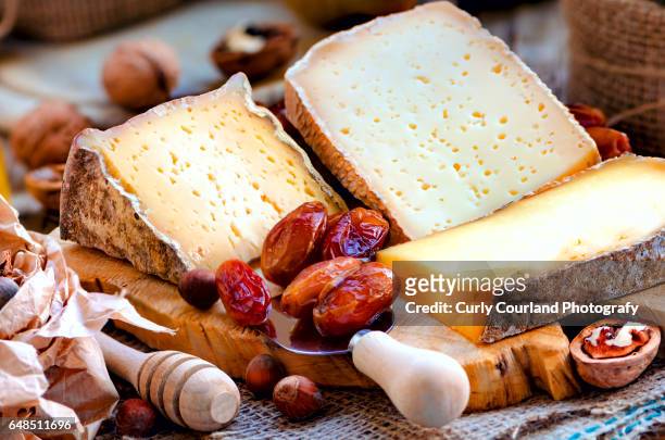 ukrainian artisanal cheeses from cow milk served with dates and nuts - walnut farm stock pictures, royalty-free photos & images