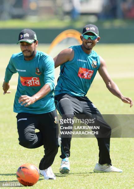 Bangladesh cricketer Mehedi Hasan and teammate Mosaddek Hossain play with a football during a practice session at the Galle International Cricket...