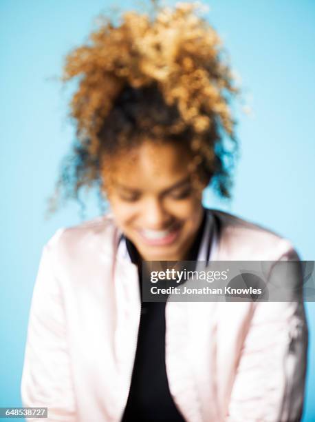blurred portrait,dark skinned female, looking down - woman smiling facing down stock pictures, royalty-free photos & images