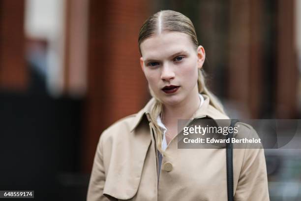 Model wears a trench coat, outside the Celine show, during Paris Fashion Week Womenswear Fall/Winter 2017/2018, on March 5, 2017 in Paris, France.