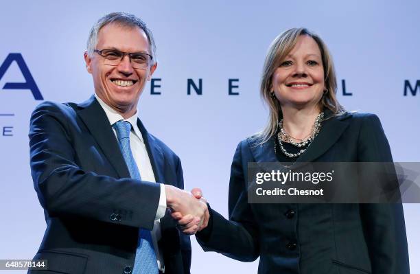 Chairman of the Managing Board of French carmaker PSA Group Carlos Tavares and Chairwoman and CEO of General Motors, Mary Barra skake hands prior to...