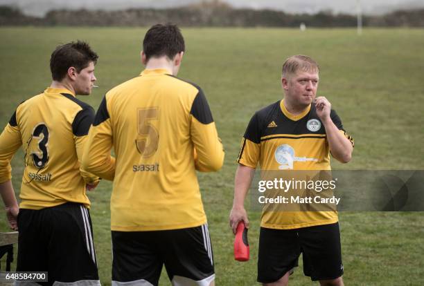 Woolpack Wanderers Matt Simons smokes a cigarette at half time during the match between the Garrison Gunners and Woolpack Wanderers at the Garrison...