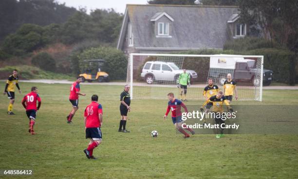 Action during the football match between the Garrison Gunners and Woolpack Wanderers at the Garrison soccer field on St Mary's on the Isles of Scilly...