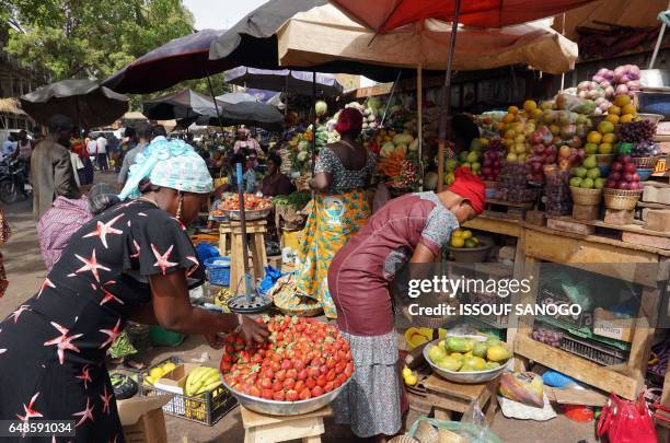 Women sale strawberries are on display at an open market in Ouagadougou, on March 6, 2017.
